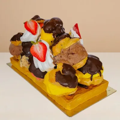 profiterole ice cream cake, shortbread base with 11 pieces of gelato-filled profiteroles