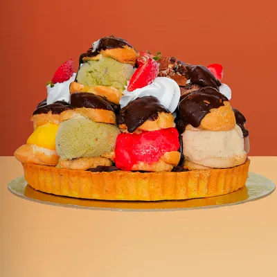 Profiterole Ice Cream Cake - 14 Pieces Profiterole ice cream cake with 14 chocolate-glazed profiteroles, mixed gelato & strawberries by Profiterole Patisserie
