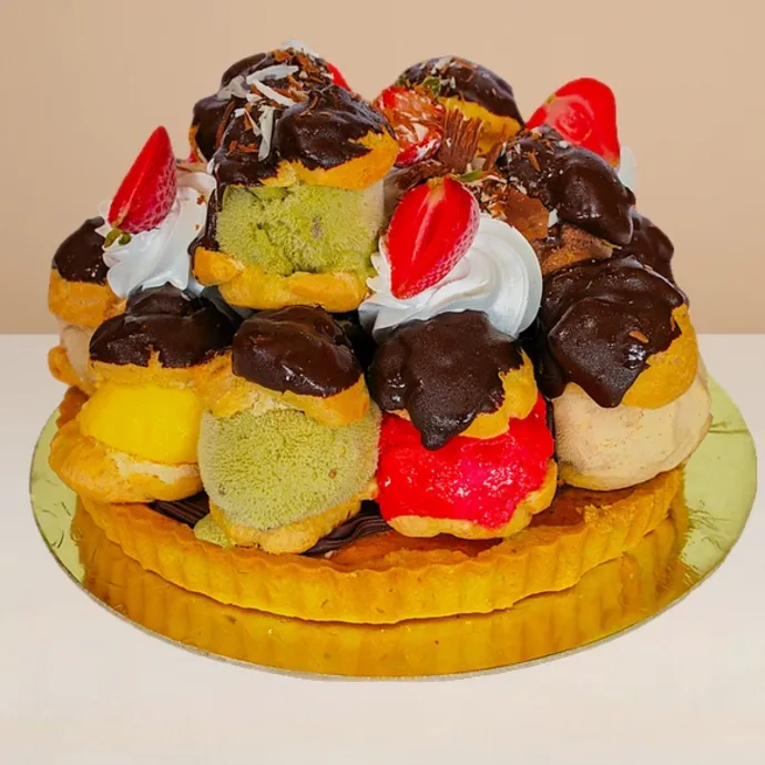 side view of the profoterole ice cream cake with shortbread base and 14 gelato-filled profiteroles
