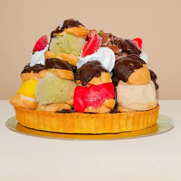 side view of the profoterole ice cream cake with shortbread base and 14 gelato-filled profiteroles