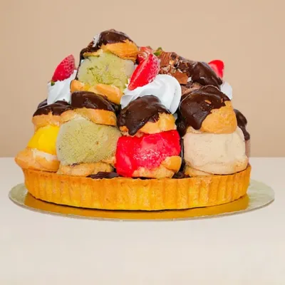 side view of the profoterole ice cream cake with shortbread base and 14 gelato-filled profiteroles