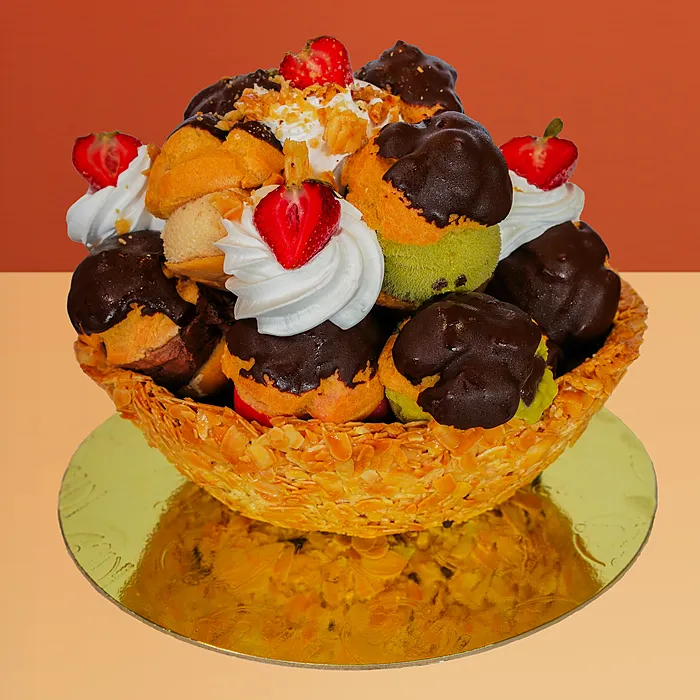 Profiterole ice cream cake with 17 gelato-filled profiteroles and whipped cream in a golden pastry basket by Profiterole 