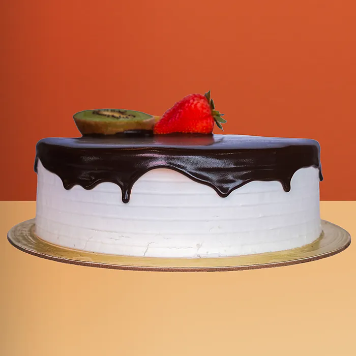 Round ice cream cake with smooth chocolate sauce drip decorated with a fresh kiwi slice and strawberry on top by Profiterole 