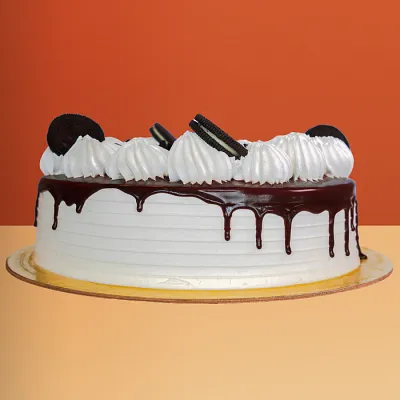 Oreo Ice Cream Cake Oreo ice cream cake with white cream base chocolate sauce drip Oreo cookies & cream dollops on top by Profiterole Patisserie