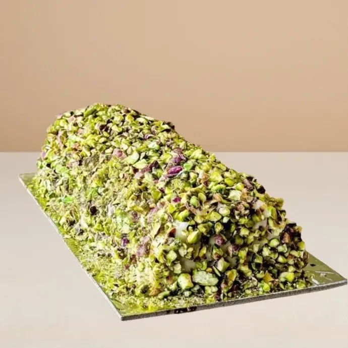 ashta ice cream cake log covered in crushed pistachio bits