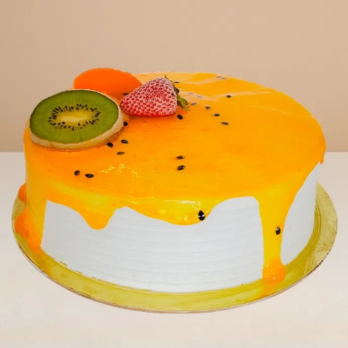 side view of the round ice cream cake showing the base vanilla sponge and some passionfruit sauce dripping