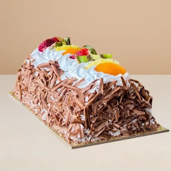 ice cream cake log with chocolate shavings and creamy and fruity toppings