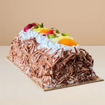 ice cream cake log with chocolate shavings and creamy and fruity toppings