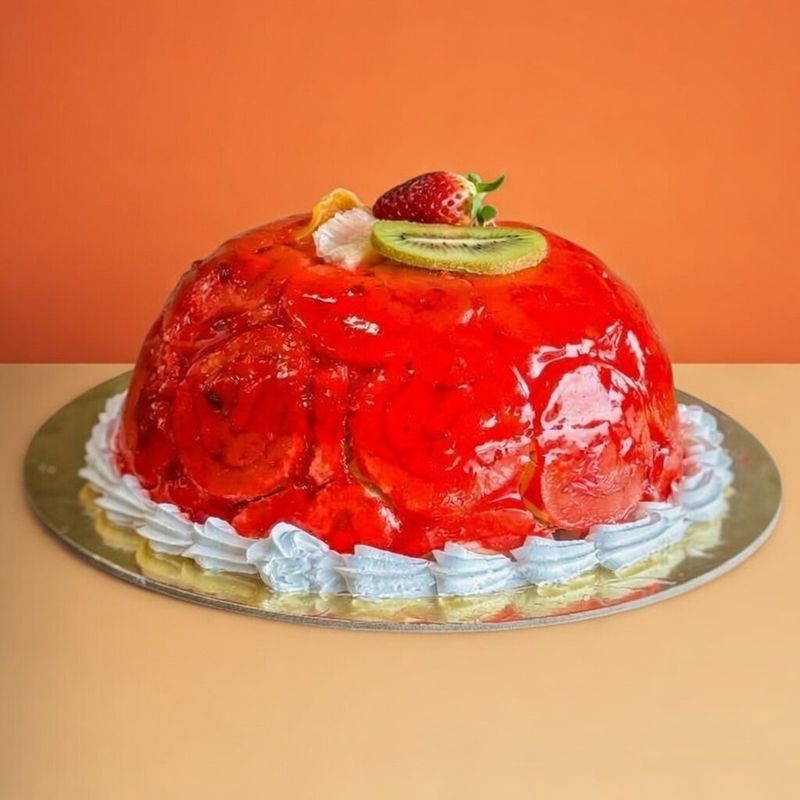 Strawberry Swiss roll ice cream cake with red glaze, fresh strawberry, and kiwi
