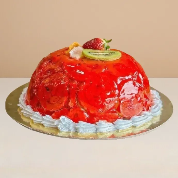 side view of swiss roll ice cream cake showing slices of the swiss roll visible through the transparent strawberry sauce