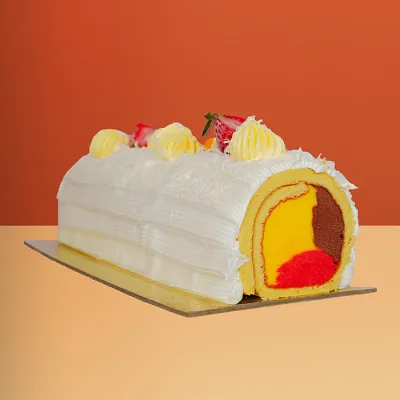 Mango Swiss Roll Ice Cream Cake Mango Swiss roll ice cream cake with vanilla sponge, yellow cream piping, mango & chocolate gelato by Profiterole Patisserie