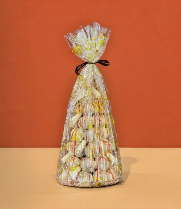 White chocolate profiterole tower wrapped and ready for a birthday party