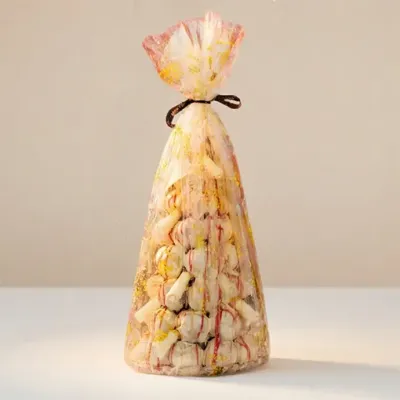 Profiterole Tower - White Chocolate white profiterole tower wrapped in a think film the vanilla filled and white chocolate dipped profiteroles are visible