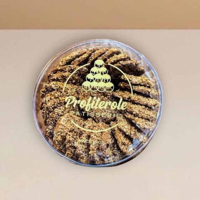 sesame cookies neatly arranged inside a clear tub