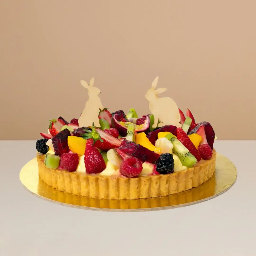 Easter cake Exotic fruit tart with shortbread base, creamy custard filling, and topped with colourful seasonal exotic fruits.