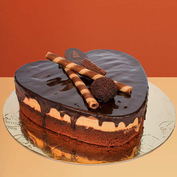 Heart-shaped trio cake with chocolate ganache drip wafer rolls and a chocolate truffle ball on top by Profiterole Patisserie