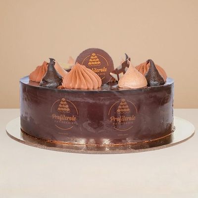 A side view of a choco cake with 2 layers of chocolate sponge pudding filled with chocolate cream at Profiterole Patisserie.