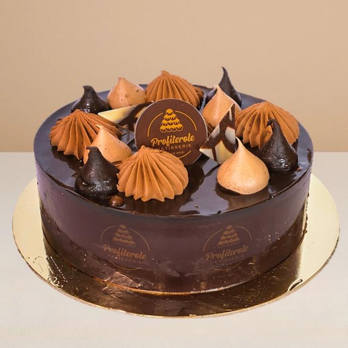 A side view of a choco cake with 2 layers of chocolate sponge pudding filled with chocolate cream at Profiterole Patisserie.