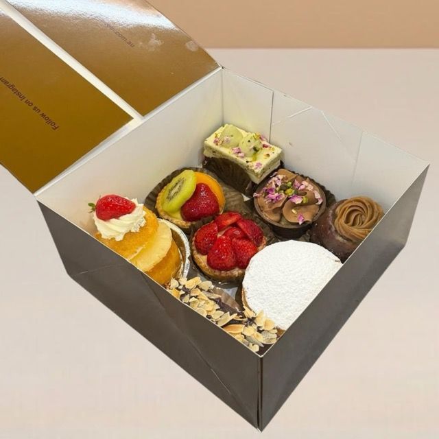 a box with 8 pieces of exotic cake slices