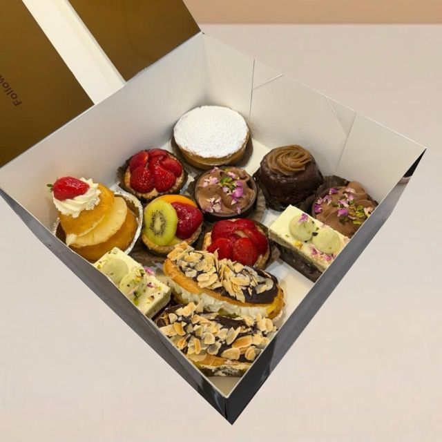 a box with 12 pieces of exotic cake slices