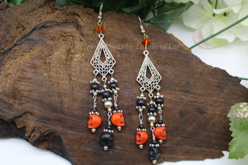 Black and Orange Skulls 3 Drop Earrings in Silver Tone