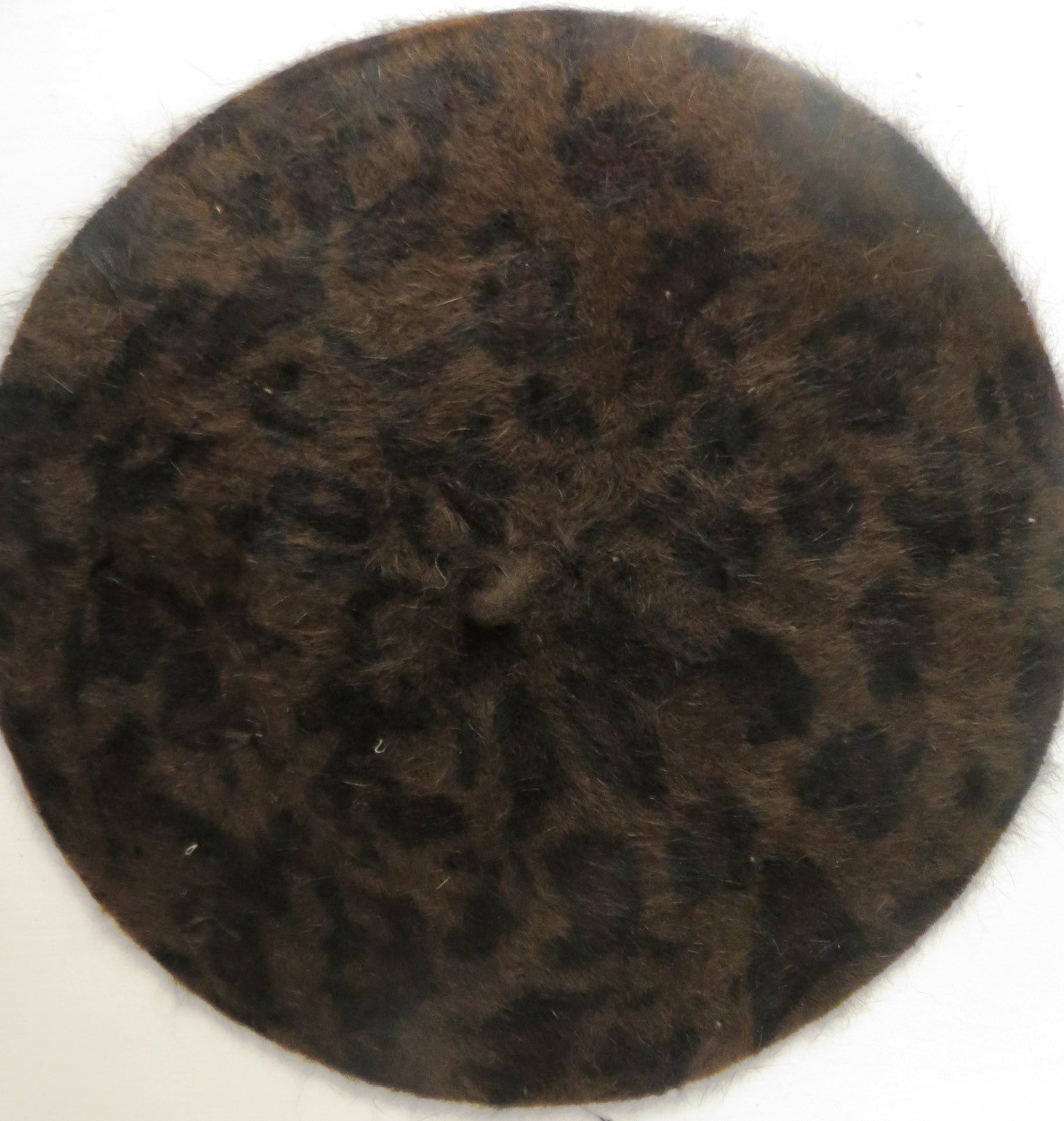 Leopard print beret dark brown background