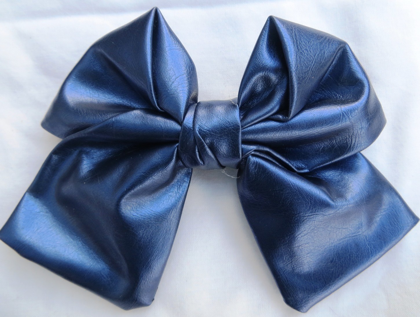 Blue faux leather metallic look bow