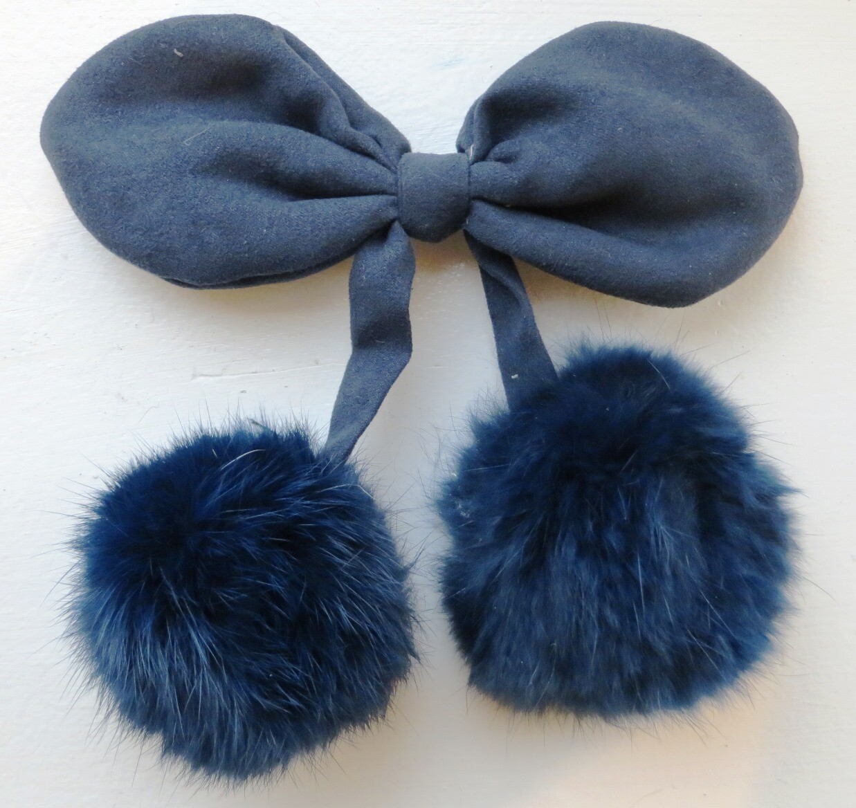 Blue bow clip with pom poms