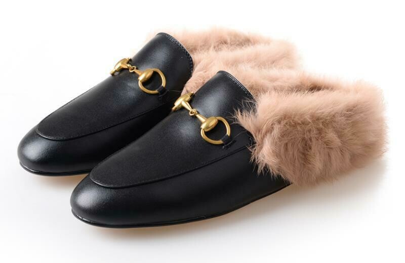 Black leather slide mules with natural fur lining