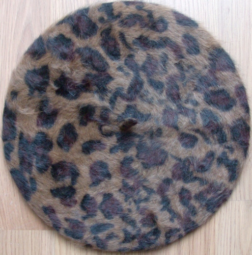Leopard print beret beige background