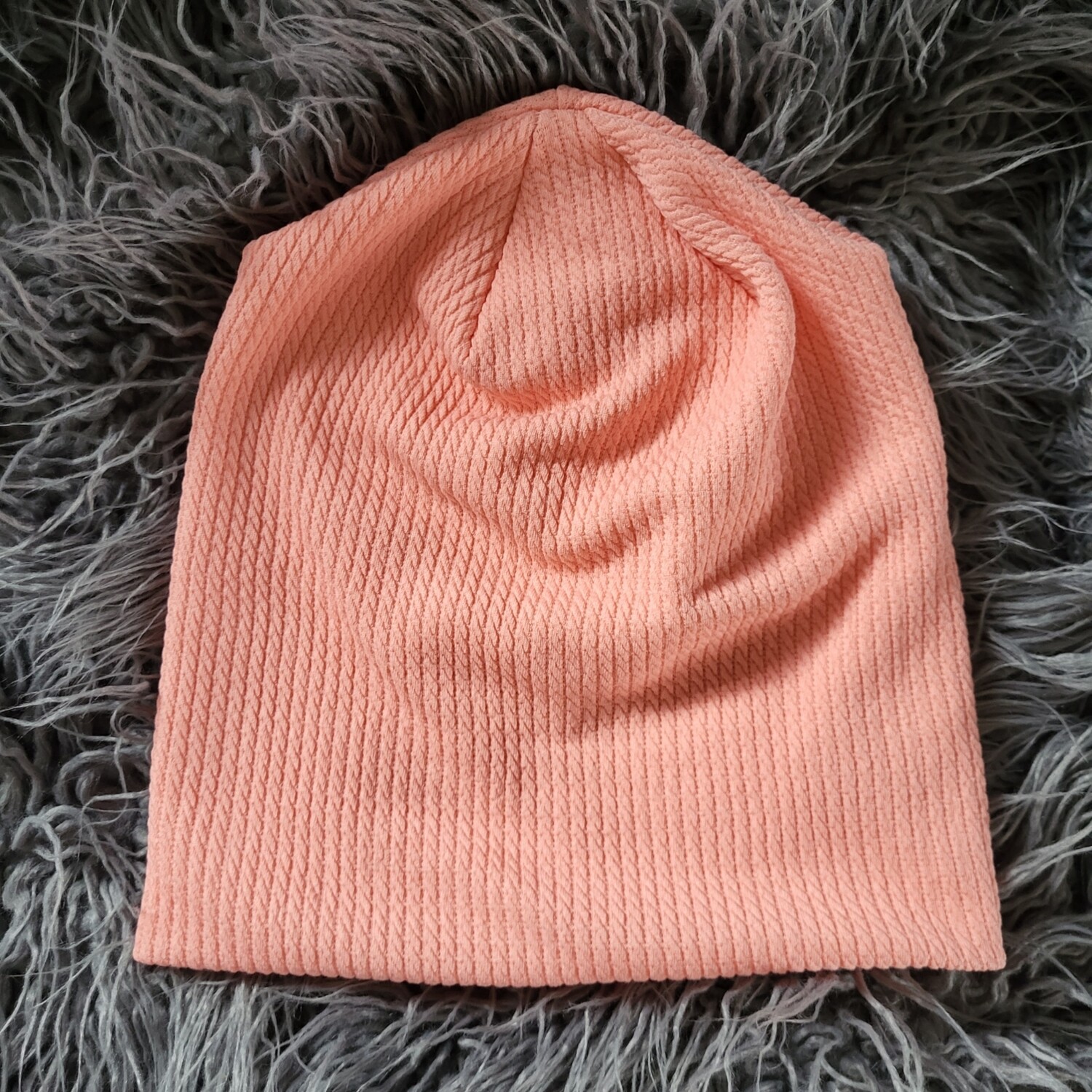 Peachy pink fine cable ribbed beanie