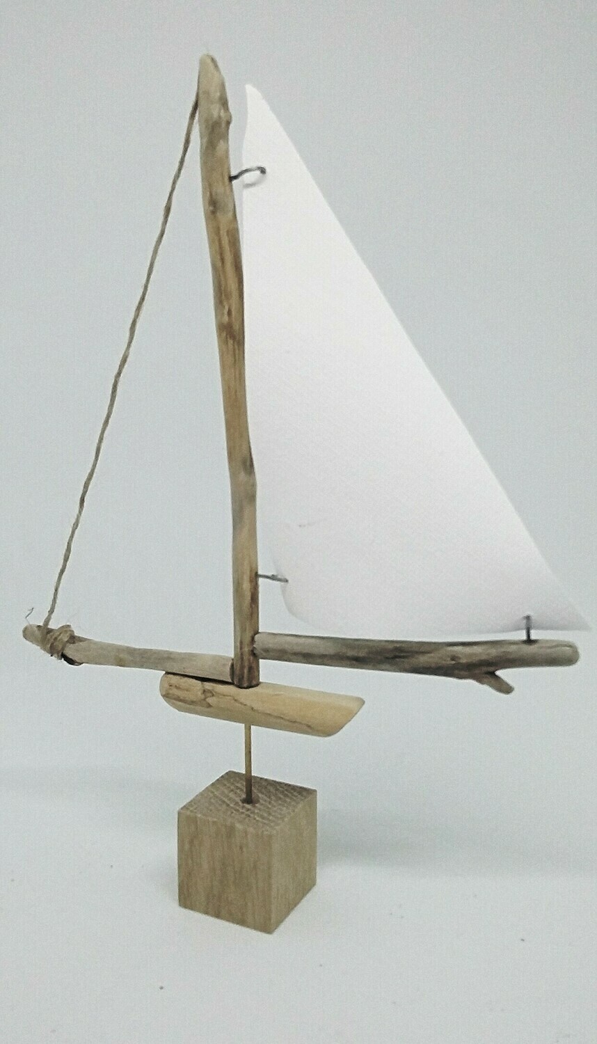 Small driftwood boat with canvas sail