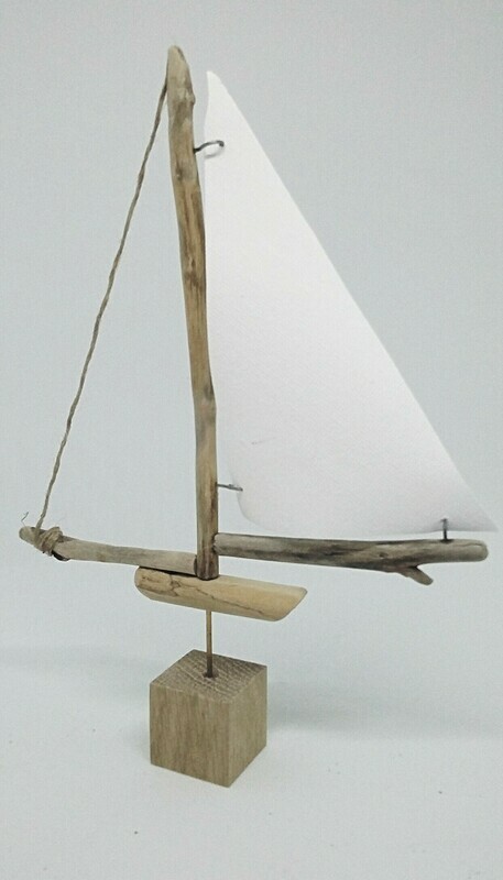 Small driftwood boat with canvas sail