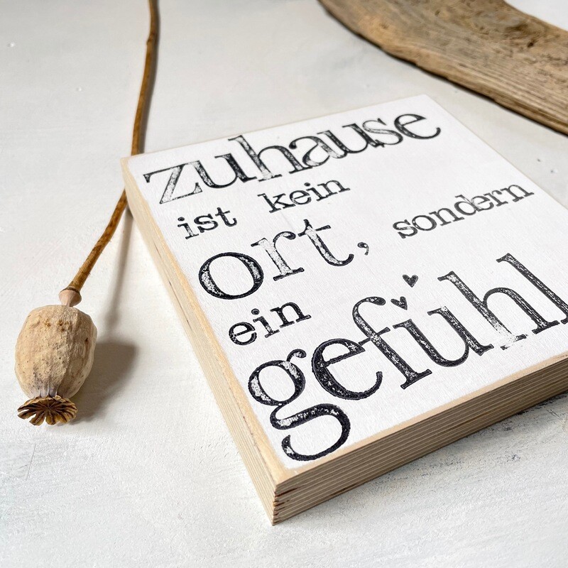 Schild Schild "Zuhause ist kein Ort, sondern ein Gefühl"