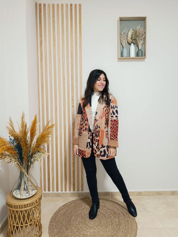 Chaqueta estilo blazer en antelina que combina el estampado animal print en tonos naranja con un diseño patchwork