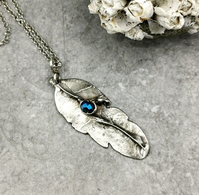 Feather Pendant with captured faceted blue bead