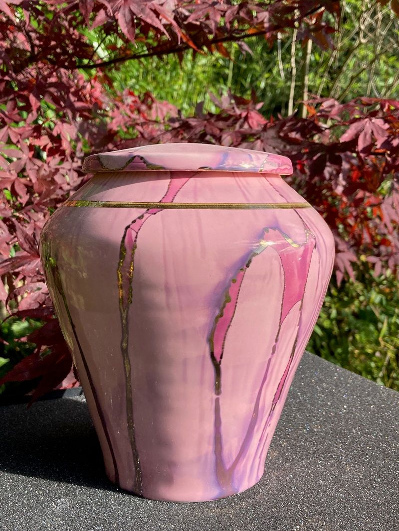 Ancient Creations ceramic cremation urn in pink with rose gold luster design, and real 22 karat gold banding.