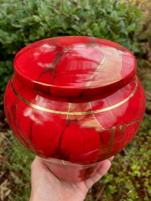 Ancient Creations ceramic cremation urn in Ruby Red with gold luster design, and real 22 karat gold banding.