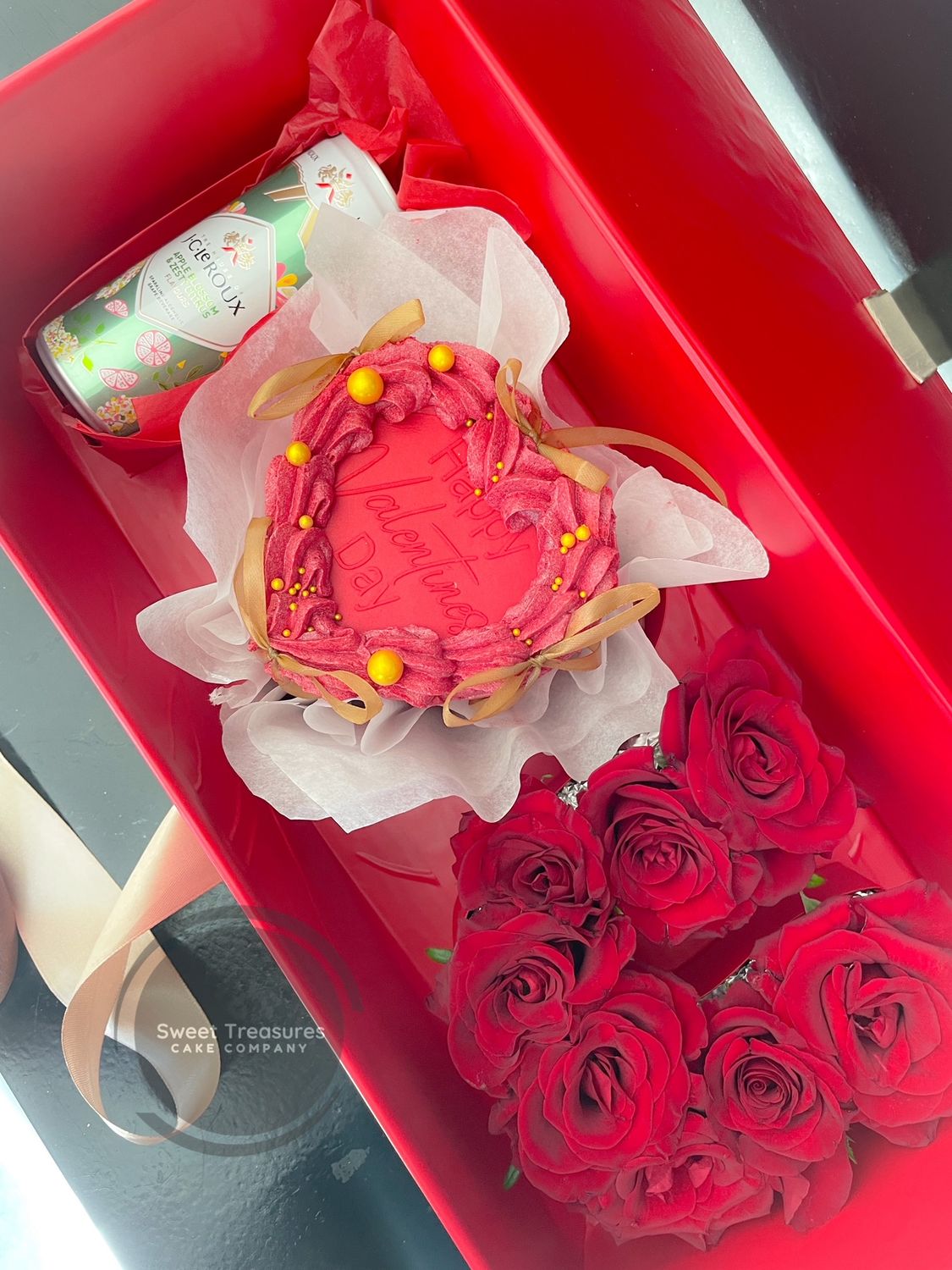  JC Le Roux Sparkling Wine (250ml) included in the romantic Love in Bloom Gift Box;  Expertly crafted heart-shaped cake from the Love in Bloom Gift Set; Elegant U-shaped floral bouquet in the Love in Bloom Gift Box