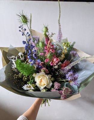 large fresh flower bouquet with delphiniums, roses and other summer flowers
