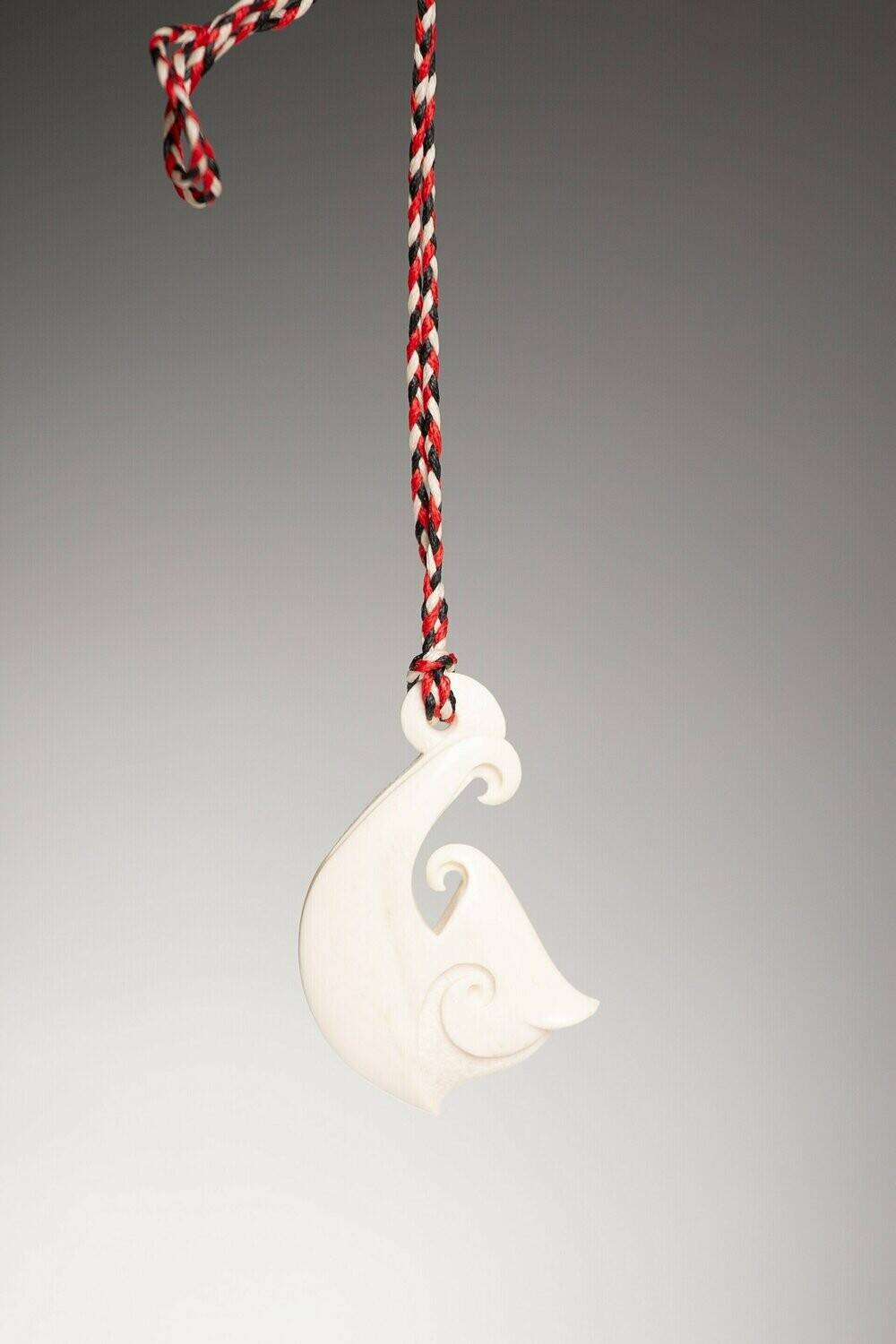 Moko Pounamu Bone Carving Stylised Hei Matau (Hook) with Engraved Piko