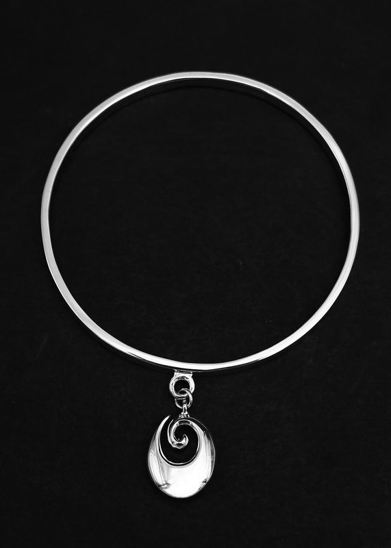 Moko Pounamu Sterling Silver Bangle with Oval Koru Charm Moko Pounamu Sterling Silver Bangle with Oval Koru Charm