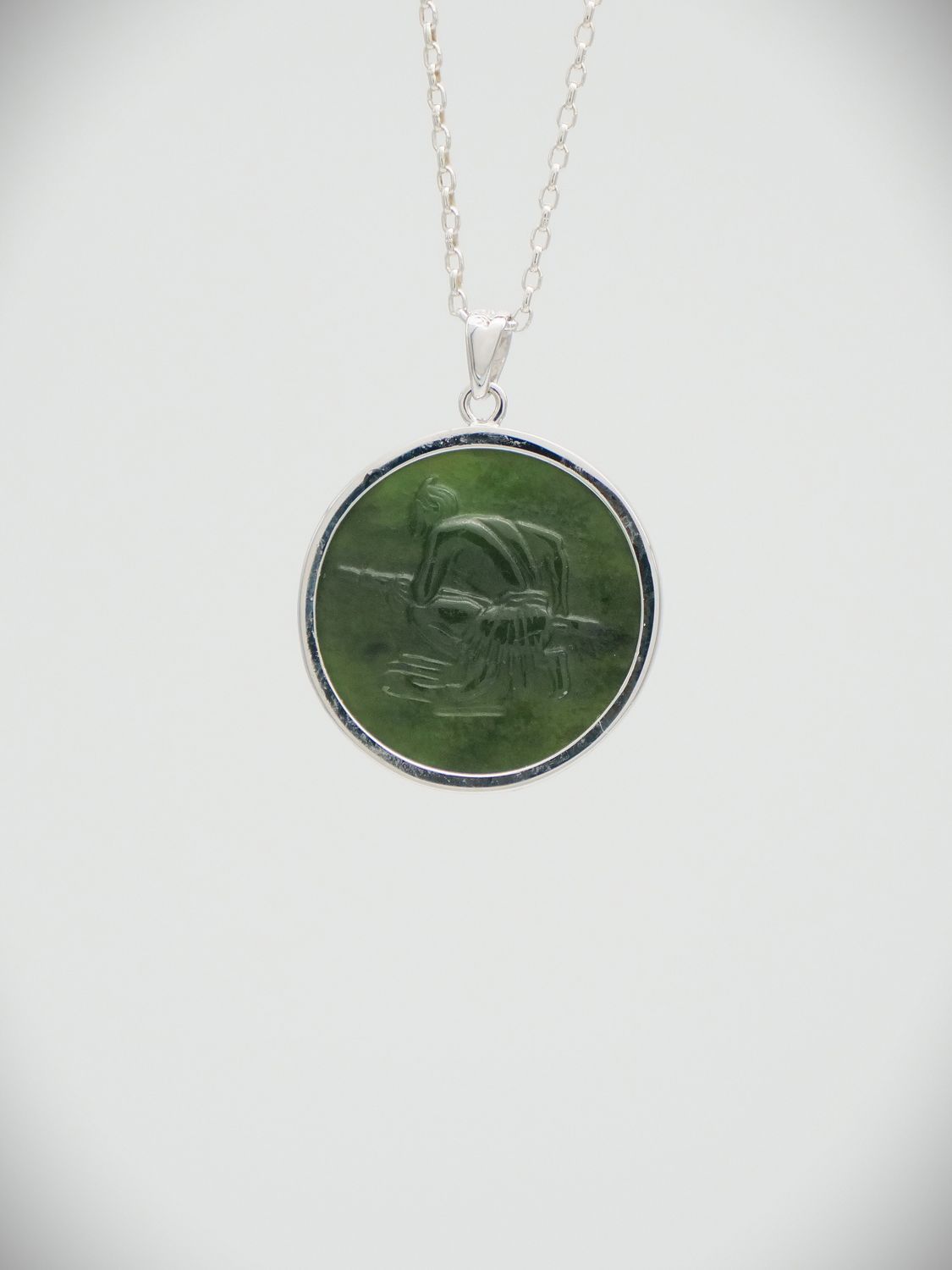 Moko Pounamu Greenstone and Sterling Silver Crouching Māori Warrior Coin Pendant