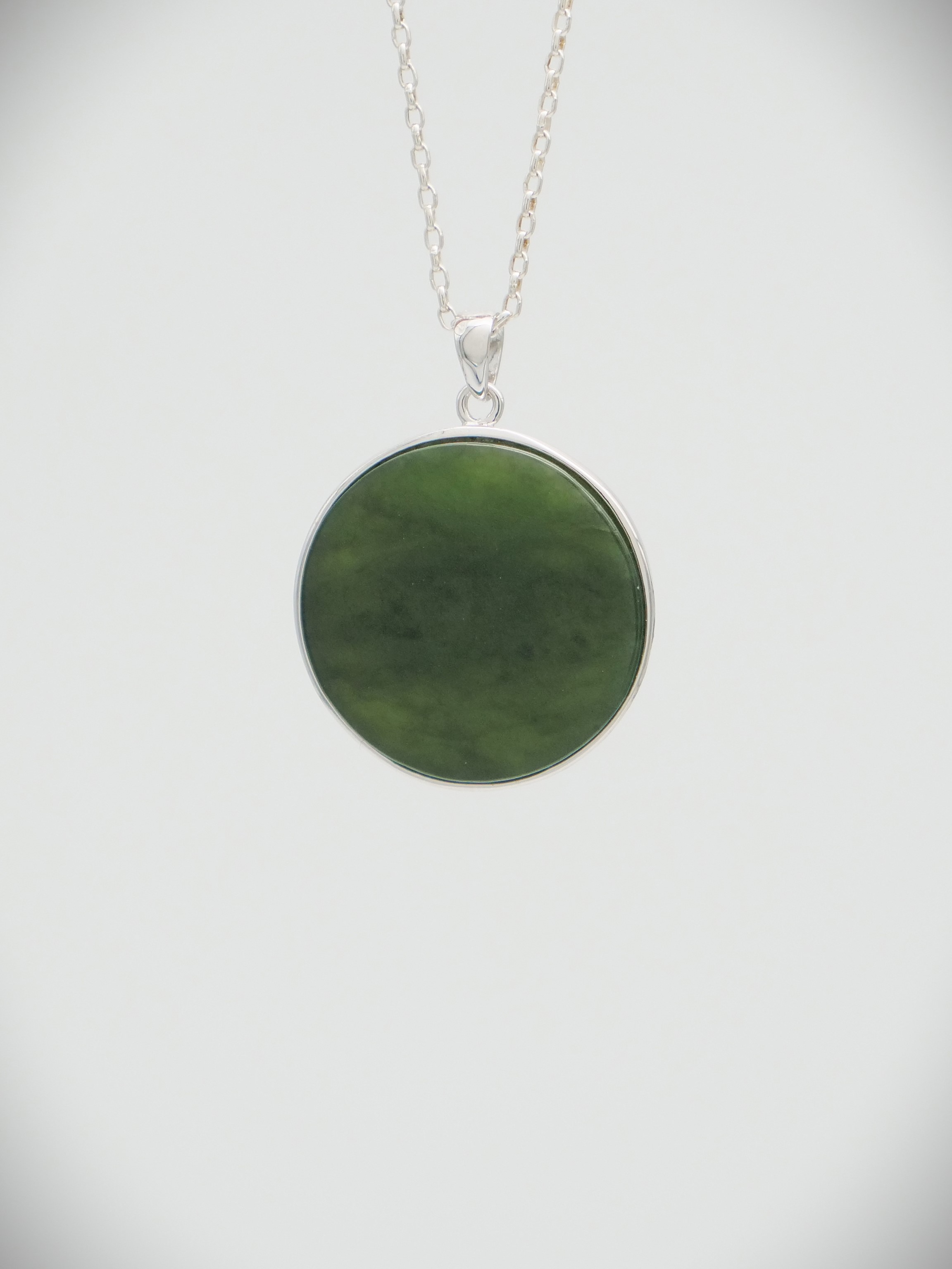 Moko Pounamu Greenstone and Sterling Silver Crouching Māori Warrior Coin Pendant