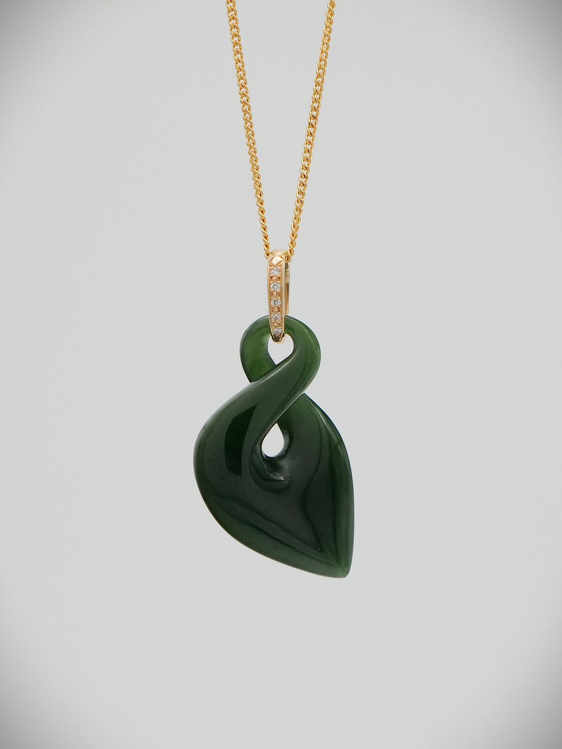 Moko Pounamu Single Pikorua (Twist) NZ Genuine Kawakawa Greenstone & 9ct Gold Diamond Pendant - Wairaurahiri Moko Pounamu Single Pikorua (Twist) NZ Genuine Kawakawa Greenstone & 9ct Gold Diamond Pendant - Wairaurahiri