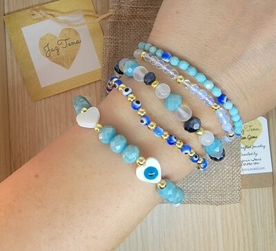 Hearts and evils eyes stack. Opal, mermaid glass, blue and gold tone bracelets