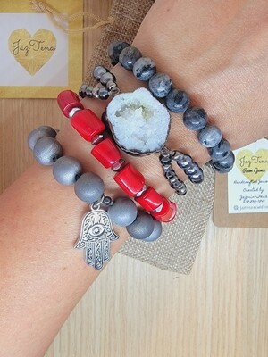 Red coral and gray agates stack. Women's bracelets are made with agates, coral, hematite, and black labradorite. White druzy geode