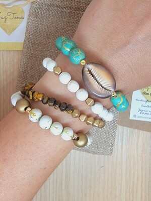 Aqua, gold, and brown cowrie stack. Bracelet set made with Howlite, tiger eye, and wooden beads.