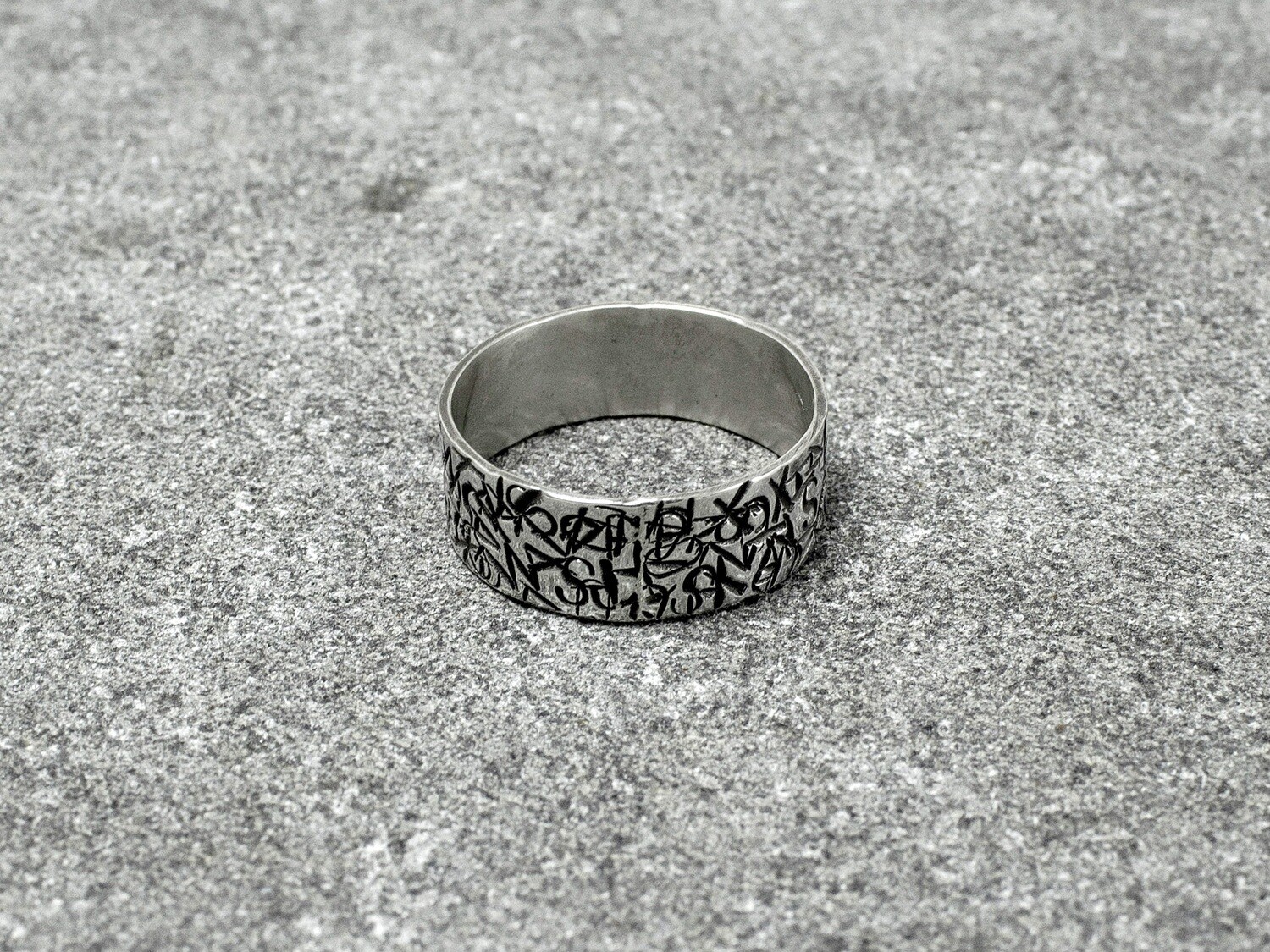 Silver ring with embossed letters