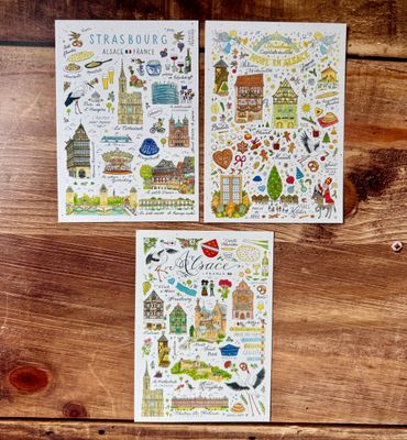 Cartes illustrées d’Alsace et de Strasbourg par Jiska de Waard (3 modèles au choix) Trois cartes illustrées de l’Alsace par Jiska de Waard, pleines de détails colorés et de charme régional.